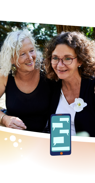 Two smiling women sitting next to one another